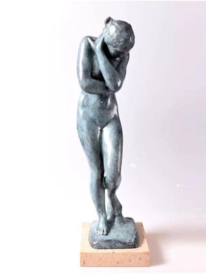 a statue of a man holding his head in his hands