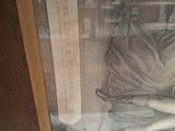 a glass case with a picture of a woman in a dress