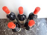 several bottles of wine are lined up on a counter top