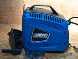 an image of a blue air compressor sitting on top of a wooden table