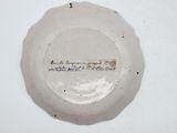 a white plate with writing on it sitting on a table