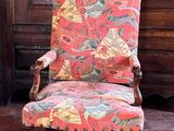 a chair that is sitting in front of a wooden door