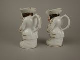 two white vases that are sitting next to each other
