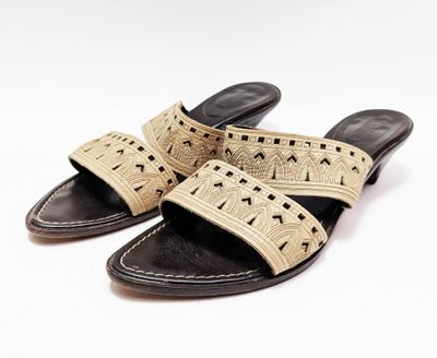 un gros plan sur une paire de sandales sur fond blanc