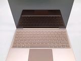a laptop with a keyboard on a white table