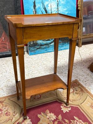 a small wooden table with a drawer on top of it