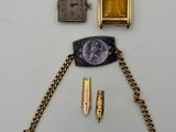 an image of a group of items including a watch, a watch chain, and a lighter