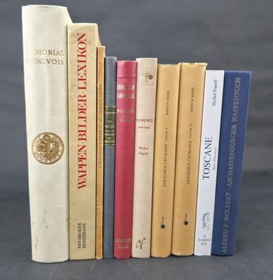 several books are lined up in a row on a gray surface