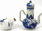 a blue and white tea pot and a white tea pot