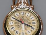 a clock on the wall with a pendulum on it