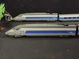 two model trains sitting next to each other on a table
