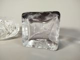 a glass block and a glass bowl sitting on a table