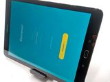 the back of a smartphone with a blue screen and a yellow button on it