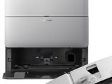 a close up of a laptop and a printer on a white surface