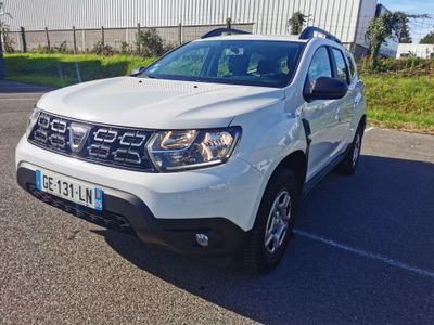 the front of a white dacia parked in a parking lot