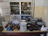many plates and bowls on a table in the kitchen