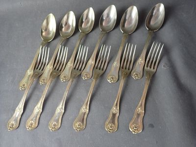 six spoons and six forks are lined up on a table