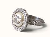 a pearl and diamond ring on a white background