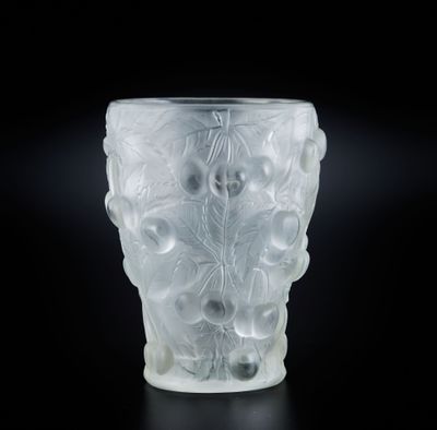 un gros plan d'un vase en verre dépoli posé sur une surface noire
