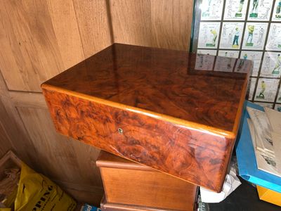 a wooden desk with a drawer on top of it