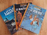 three books that are sitting on a wooden table