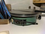a crock pot sitting on a counter next to a stack of cd ' s
