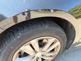 a close up of a car ' s tire on the road
