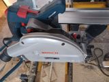 someone is using a circular saw to cut a piece of wood
