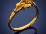 a close up of a gold ring with a horse head on it