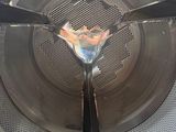 a close up of a metal basket with a spoon inside of it