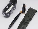 a pen, a pen case, and a pen on a table