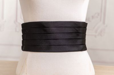 a close up of a mannequin torso with a black belt