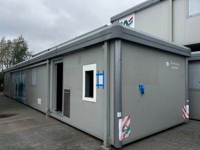 a small building with a door and windows on the side of the building