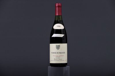 a bottle of wine sitting on top of a glass table