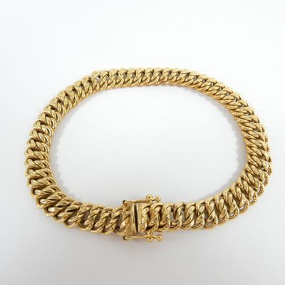 a gold chain bracelet with a clasp on a white background