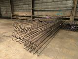 a large pile of steel pipes sitting in a warehouse