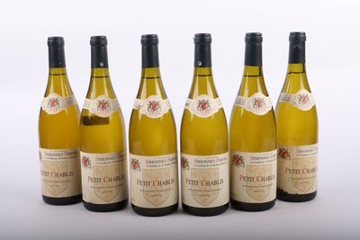 six bottles of wine are lined up in a row on a white surface
