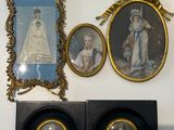 three framed pictures on the wall of a room