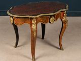 a small table with a red and gold decoration on it