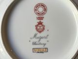 a white plate with a red and black design on it