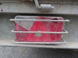 a red and white sign on the back of a truck