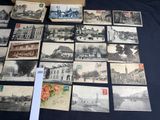 many old postcards on a table with a box of them