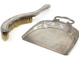 une paire de brosses plaquées argent et une brosse posée sur une surface blanche
