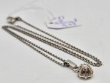 a close up of a necklace with a chain attached to it