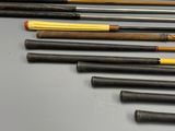 a lot of different types of fishing rods on the table
