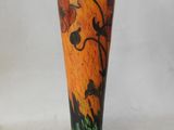 a vase with a painting on it sitting on a table