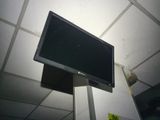a television mounted on a pole in a room