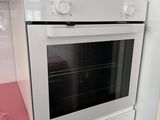 a white oven with a pink counter top in a kitchen