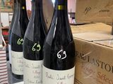several bottles of wine sit on a table in a store
