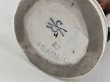 an image of a close up of a vase with a bird on it